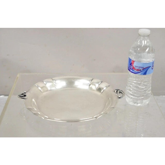 Vintage Denmark Art Nouveau Round Silver Plated Dish with Scrolling Handles. Circa Mid 20th Century. Measurements: 1" H x...