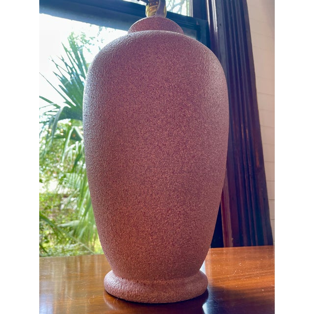 Large ceramic table lamp in the '80s Palm Beach style featuring a textured pastel pink vessel measuring 5"W at the base,...