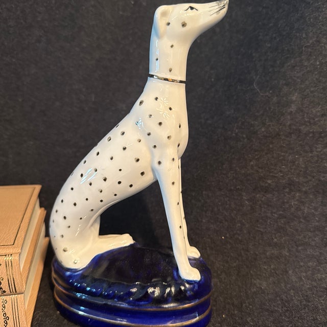 Sitting Dalmation on royal blue pillow with gold trims