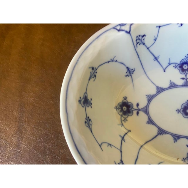 Traditional blue & white motif; the bowl has a scalloped rimmed profile.