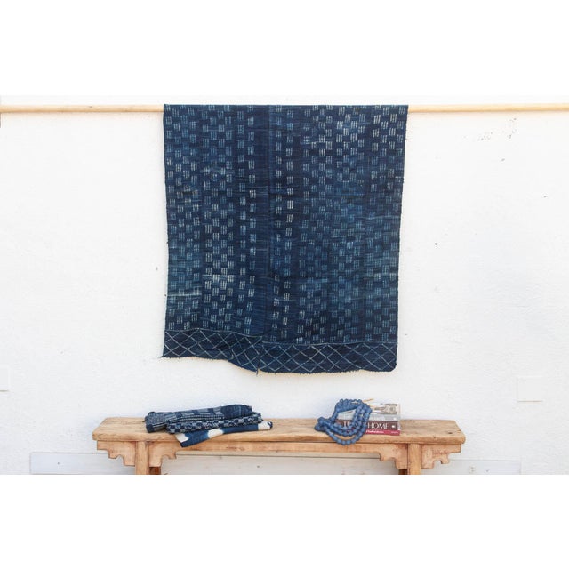 A masterwork of Malian textile heritage featuring deep indigo saturation and symbolic geometric motifs. Originating from...
