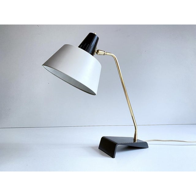 Kaiser Desk lamp, Modell 6813, 1960s, featuring a cantilivered black enameled cast iron base, brass stem and superimposed...