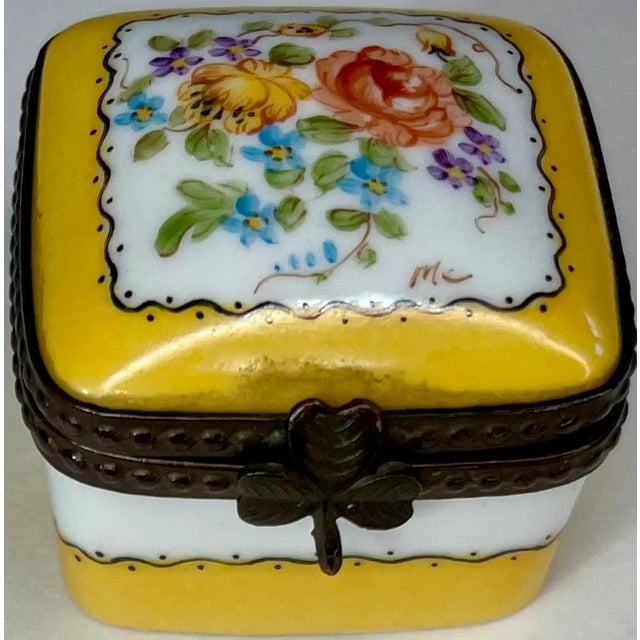 A finely detailed French Limoges trinket box, hand painted with florals and ideal for gifting or display. A hand painted...