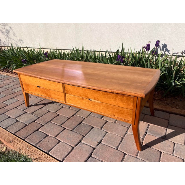 These classic matching Mid-Century Modern Danish Teak tables have tapered and curved legs and smoothly operating drawers...