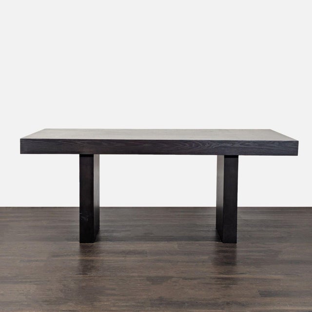 This West Elm dining set features a sturdy black wood table, a matching bench, and two chairs with woven seat cushions....