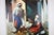 Moroccan Orientalist oil on canvas painting of a 19th century Moroccan market scene with an old men seating on a carpet...