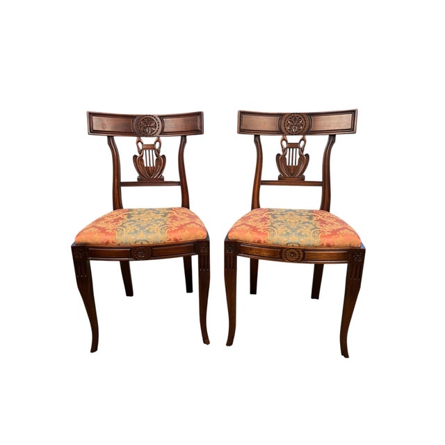 A refined pair of American Empire Revival dining chairs, dating to the late 19th to early 20th century. Executed in the...