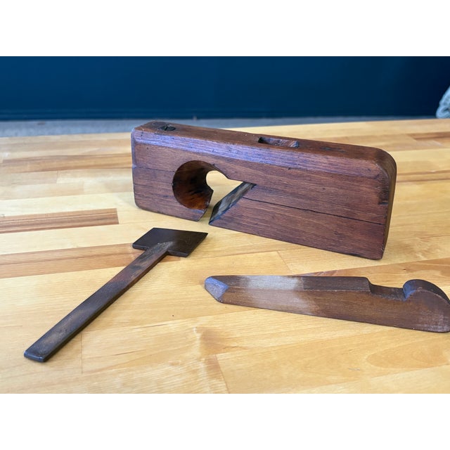 Antique handcrafted wood plane 9.5 inches long with a forged steel cutting blade.