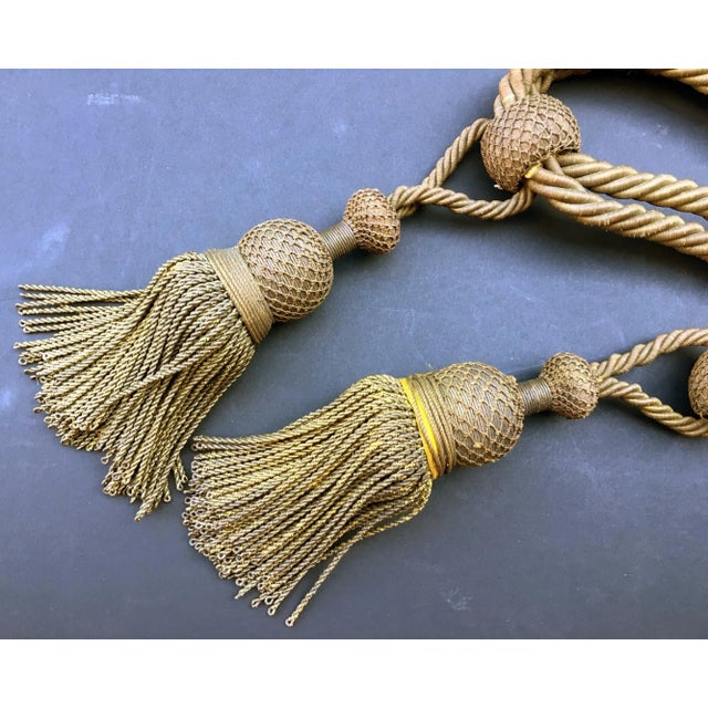 This French antique passmenterie is created, circa 1800. A round netted top is connected with a thick twisted metallic...