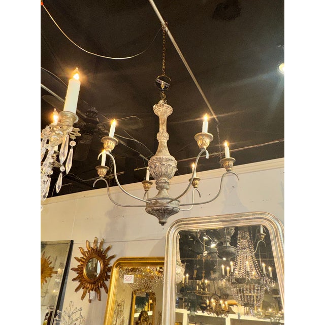 The Italian Wood and Iron Silver Leaf Chandelier is a stylish and charming lighting fixture perfect for a stylish home....