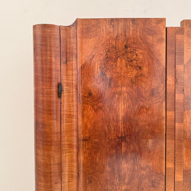 This elegant Italian Art Deco cupboard showcases exceptional craftsmanship and refined design from the 1930s. Finished in...