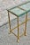 Elegant vintage brass and glass console table featuring a sleek rectangular design with neoclassical influences. The table...