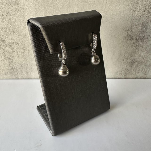 Enhance your collection with these exquisite Drop Earrings featuring Pearls and Diamonds in 14k White Gold. The elegant...