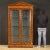 Italian showcase from the second half of the 20th century. Furniture carved and veneered in walnut, maple, exotic wood and...