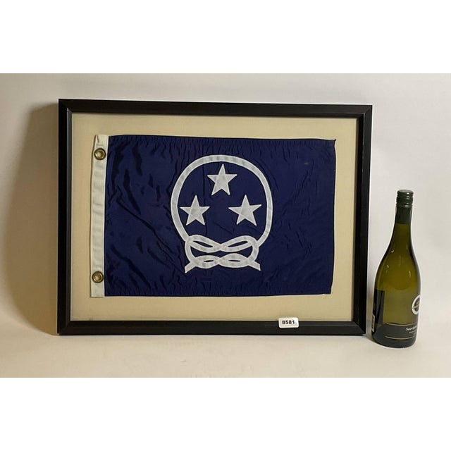 Nautical Boat Flag in Frame. Yacht club commodores flag showing three stars surrounded by a knotted rope. White hoist with...