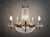 Bring an aura of classic luxury into your home with this exquisite antique French Empire-style chandelier. Defined by a...