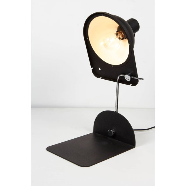 1970 black satin enamel and chrome desk lamp or wall shelf lamp by Italian lighting company Luci, printed "Luci...