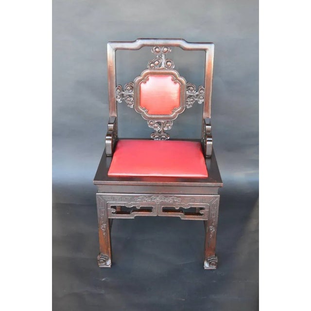 Set of eight Chinese chairs with red leather backs and seats, hand-carved mahogany wood.
