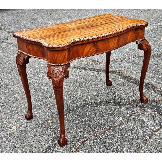 An Early 20th Century Chippendale Flame and satin Mahogany Fold-top Console Table / Card Table. Measures 39" in width,...