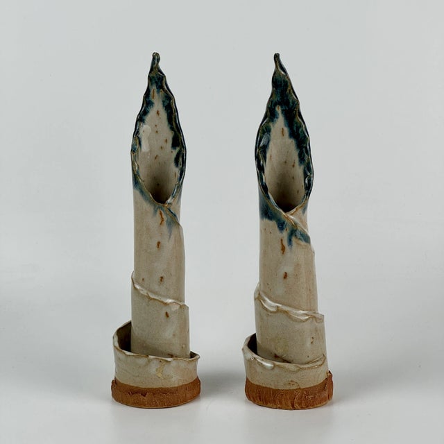 A beautiful and uncommon pair of ceramic vintage candlestick holders. Twirling upward to finish in a flaming victory. Hand...