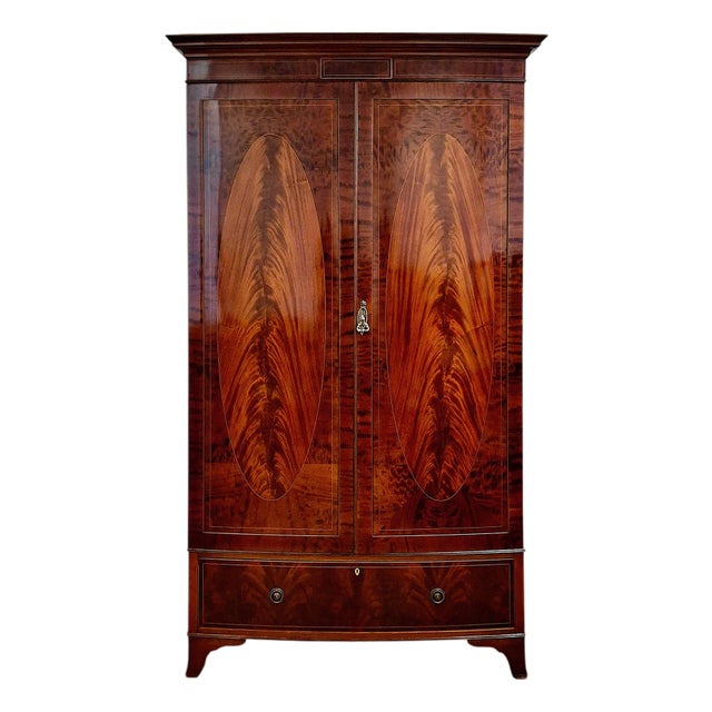 Early 20th Century Irish Flame Mahogany Bow Front Armoire in the Style of Robert Strahan & Co. For Sale