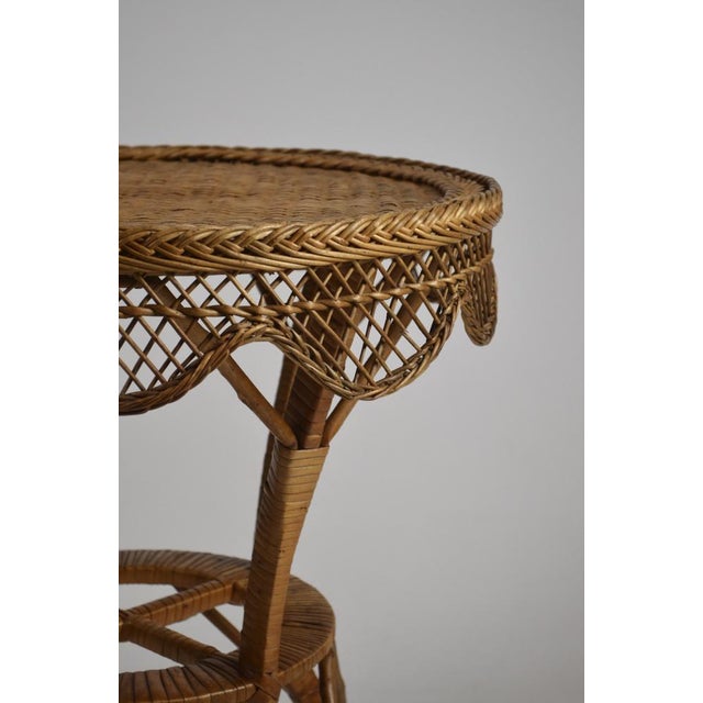 Charming vintage rattan and wicker side table dating from the 1960s, featuring a beautifully handwoven circular top with a...