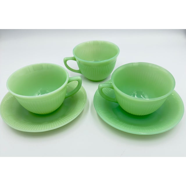 Add a touch of vintage charm to your kitchen with this beautiful Fire King Jane Ray Jadeite cup and saucer set by Anchor...