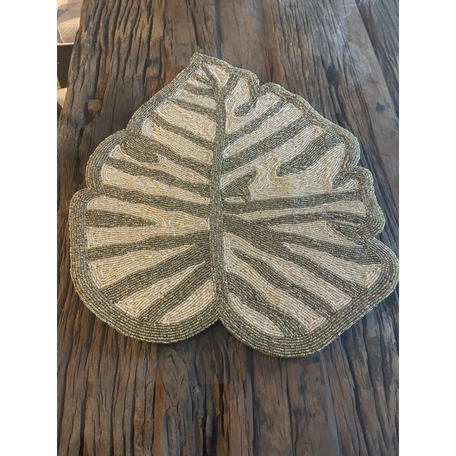 Pair of table top placemats as tropical leaves beaded.