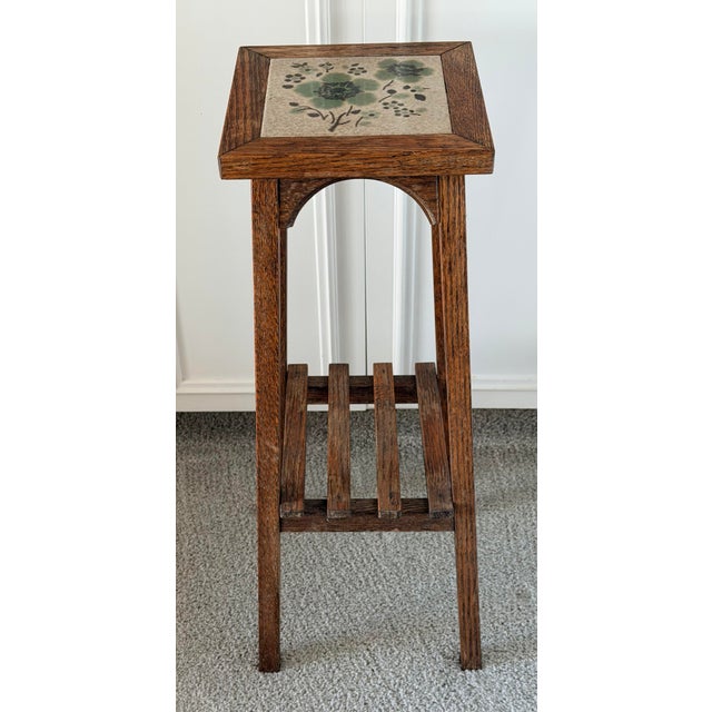 Charming tile top table with splayed legs and graceful arches attributed to Stickley. Solid construction with attention to...