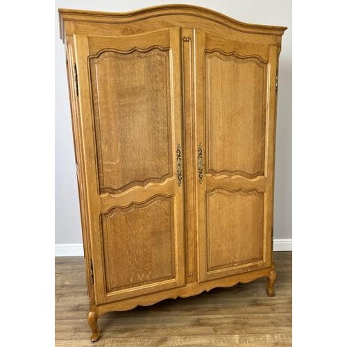 A charming and elegant Vintage French Louis wardrobe , beautifully proportioned and finished in warm oak tones with...