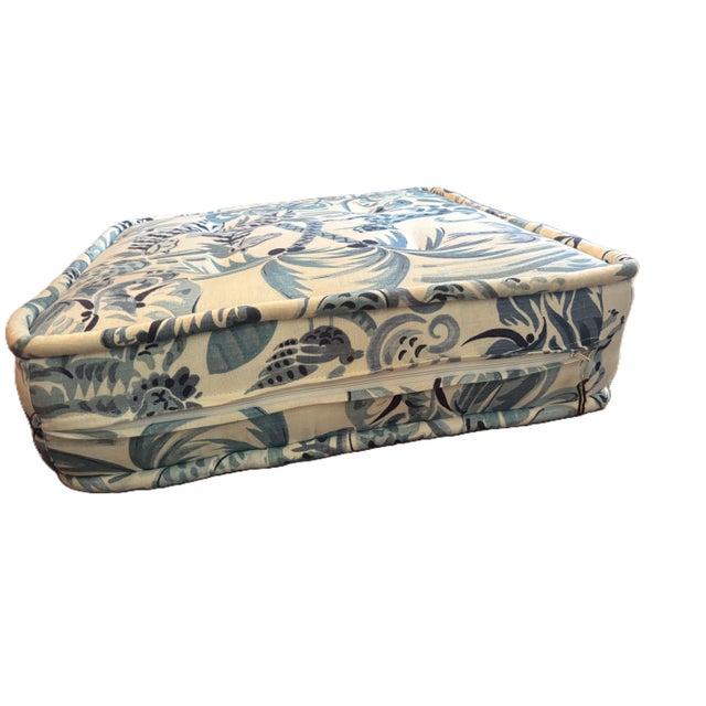 A plush, tufted Clarence House floor cushion in pattern Congo. The jungle depicted in shades of blue and white creates a...