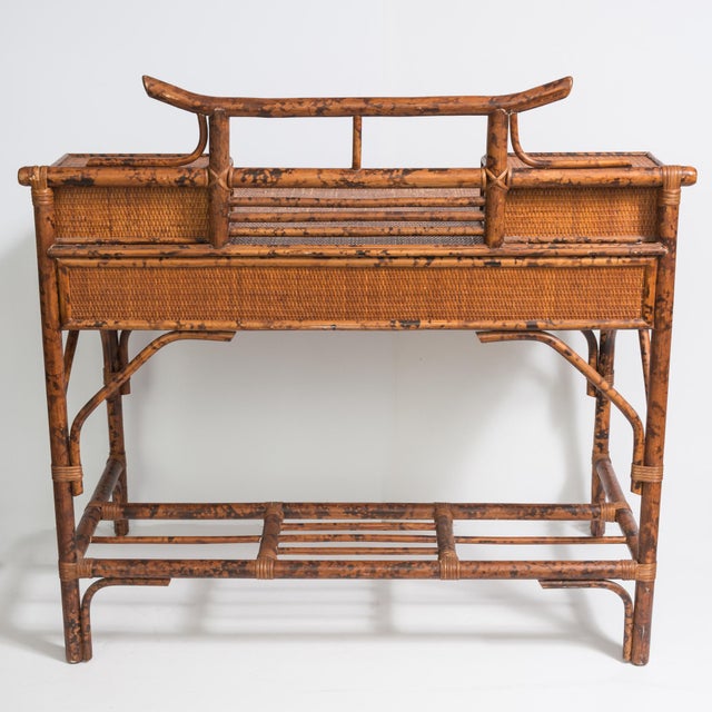 This a wonderful Vintage British Colonial Chinoiserie Style Pagoda Desk . Made of Rattan and Grasscloth. Very nicely...