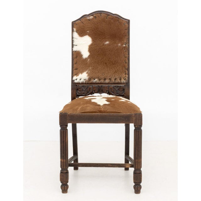 Cow Hide Upholstered Side Chair, with fluted front legs and carved floral motif to base of backrest. 40" H x 18" W x 20"...