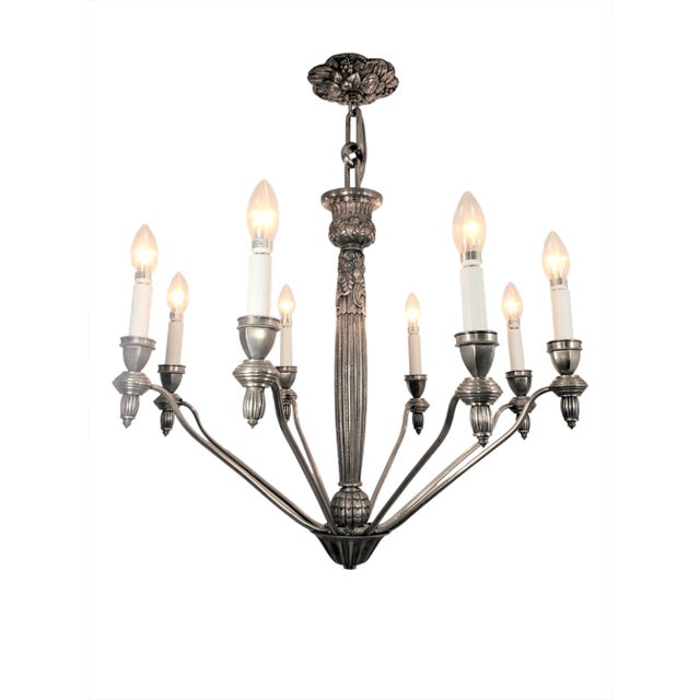 Fine and exquisite original French chandelier boasts eight beautifully cast, heavy nickeled bronze arms, each suspended...