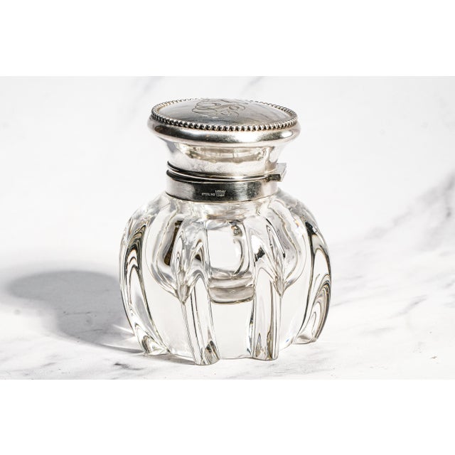 A striking expression of the Art Nouveau movement, this exceptional antique crystal and sterling silver inkwell transforms...