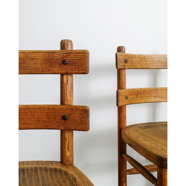 A very rare and iconic set of early swedish mid century modern "sandhamn" dining chairs in carved stained pine wood with...
