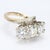 This 14k gold cocktail ring is a striking piece of craftsmanship. Featuring three round white diamonds, the central stone...