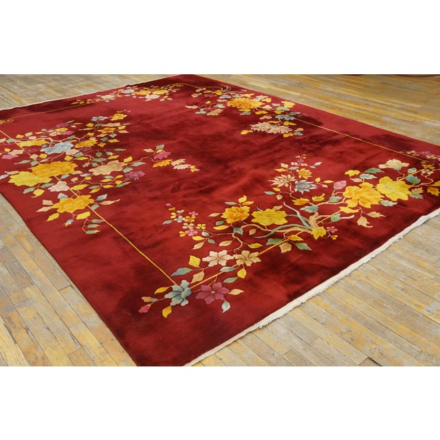 A flower basket is suspended into the red field by a thin cord from a rosette and stem upper design, while a more...