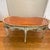 French style coffee table with 5 curved cabriole legs terminating in scroll feet. The apron features ornate, heavily...