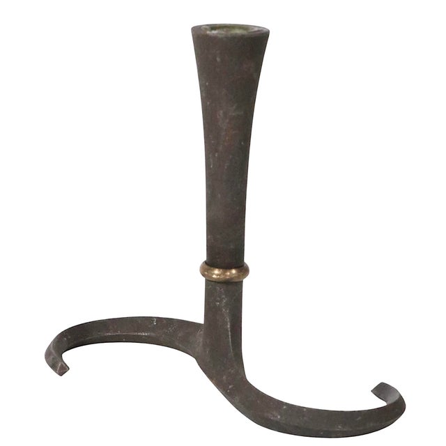Set of three iron and brass candlesticks, design by Jens Quistgaard for Dansk, circa 1960's. The chandlesticks are in very...