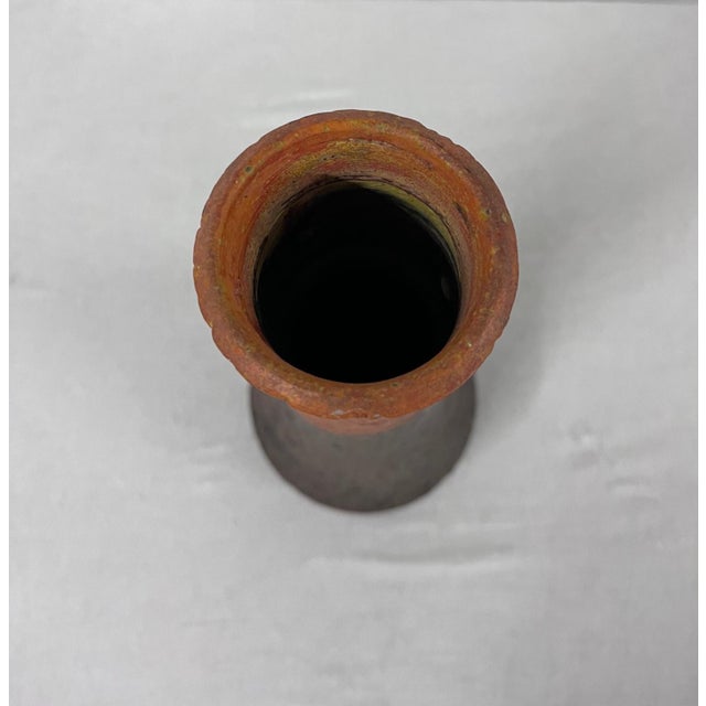 Ceramic vase created by Marcello Fantoni. Characterized by its textured, matte glaze, which is a common feature of...