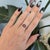 A 3.27-carat star ruby displays a soft six-rayed star across its domed cabochon, set in solid 14K rose gold with two...