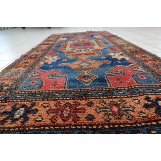 A charming vintage German rug dating from the 1950s, featuring a bold tribal-inspired geometric design and a rich, vibrant...