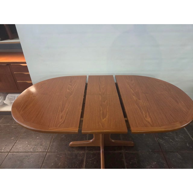 This is a apartment size pedestal oval dining table teak made by G-plan E Gomme company 1970. The leaf pops up and table...