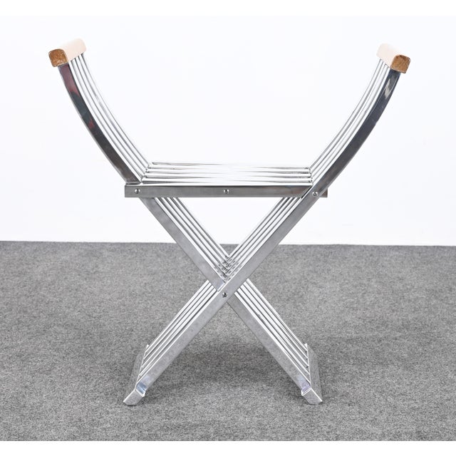 A modernist John Vesey Savonarola Folding Chair circa 1958. The folding bench or chair is made of polished aluminum and...