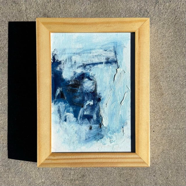 A softly textured abstract in layered blues, aquas, and warm tones, this painting evokes light moving across water and...