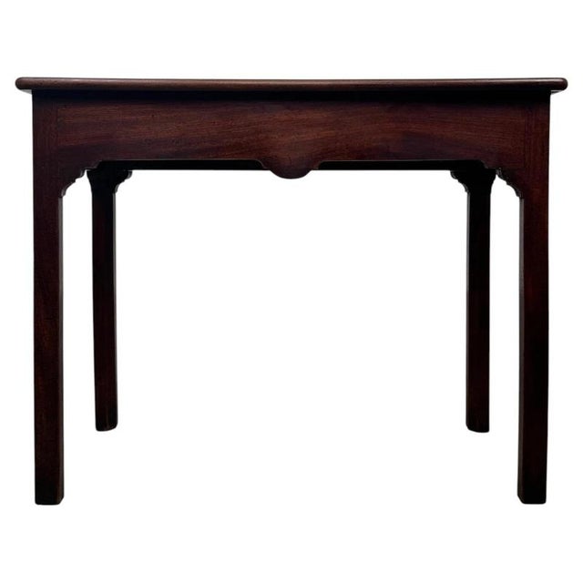 A handsome 18th-century English Georgian side table, finely crafted from mahogany and distinguished by its restrained...
