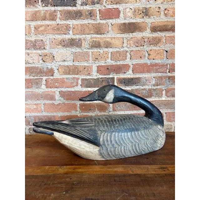 An exceptional, investment-quality vintage hand-carved Canada Goose hunting decoy. This striking hollow-body bird is...