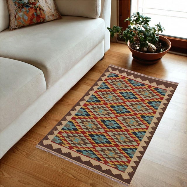 Add a touch of elegance to your home with this casual chic hand woven Tribal Kilim wool rug. Constructed on a loom by...