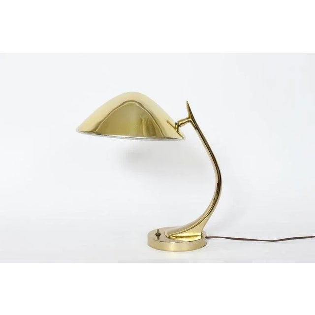Midcentury Maurizio Tempestini for Laurel lamp Co. All brass table lamp, 1960s. Featuring a curved Brass arm, adjustable...